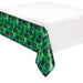 Green plastic tablecover with an all-over pattern of video game controllers, arcade cabinets, and gaming icons in black and gray, displayed draped over a white table.