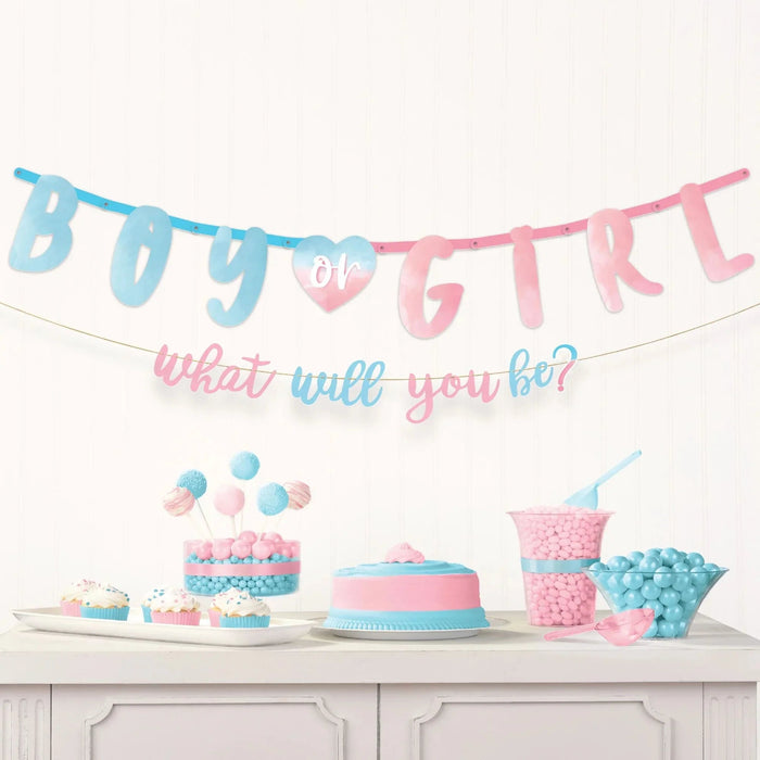 Blue and pink letter banner spelling "Boy or Girl" with a heart, accompanied by cupcakes, a layered cake, and candy-filled containers in matching pastel colors for a gender reveal party.