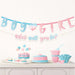 Blue and pink letter banner spelling "Boy or Girl" with a heart, accompanied by cupcakes, a layered cake, and candy-filled containers in matching pastel colors for a gender reveal party.