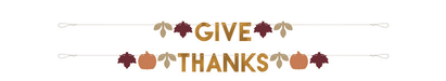 Decorative "Give Thanks" banner featuring tan letters with autumn leaves and pumpkins in shades of burgundy, orange, and gold arranged on two strands.