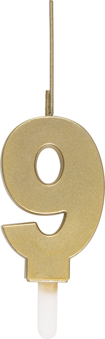 Gold number 9 birthday candle with a thin metal pick and white wax base.