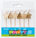 Set of six gold star-shaped birthday candles with wooden sticks in a clear plastic package with blue Party labeling.
