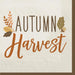 White beverage napkin with "Autumn Harvest" text in orange and brown lettering, decorated with autumn leaves and acorns in shades of orange, gold, and brown.