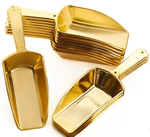 Set of twelve gold-colored metal scoops with handles in various sizes, arranged in a scattered display against a white background.