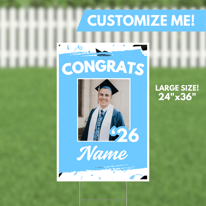Light blue yard sign featuring "CONGRATS" text, a custom photo placeholder of a graduate in cap and gown, the year "26", and a name field, measuring 24 inches by 36 inches.