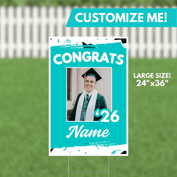 Turquoise yard sign with white text reading "CONGRATS" and "'26" flanking a customizable photo frame, with space for a graduate's name below.