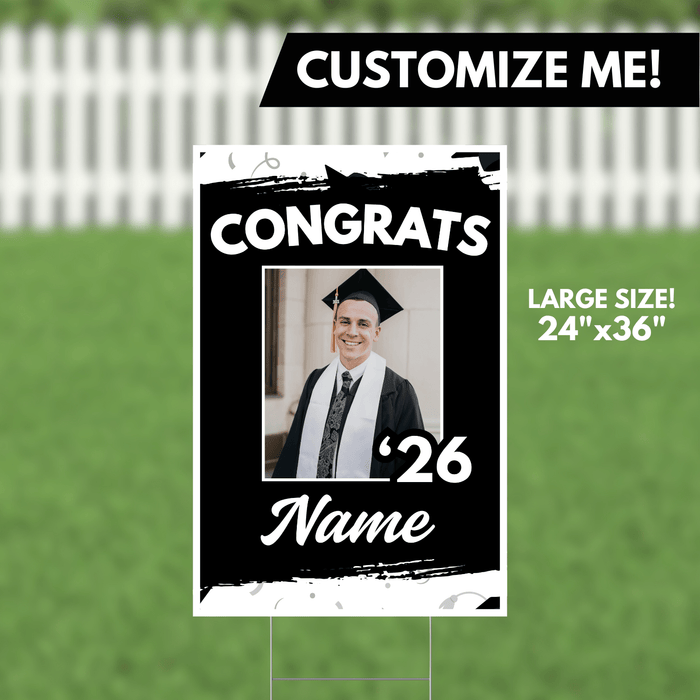 Large black and white yard sign with "CONGRATS" text, a photo placeholder for a graduation photo, "'26" graduation year, and customizable name field, measuring 24 inches by 36 inches.