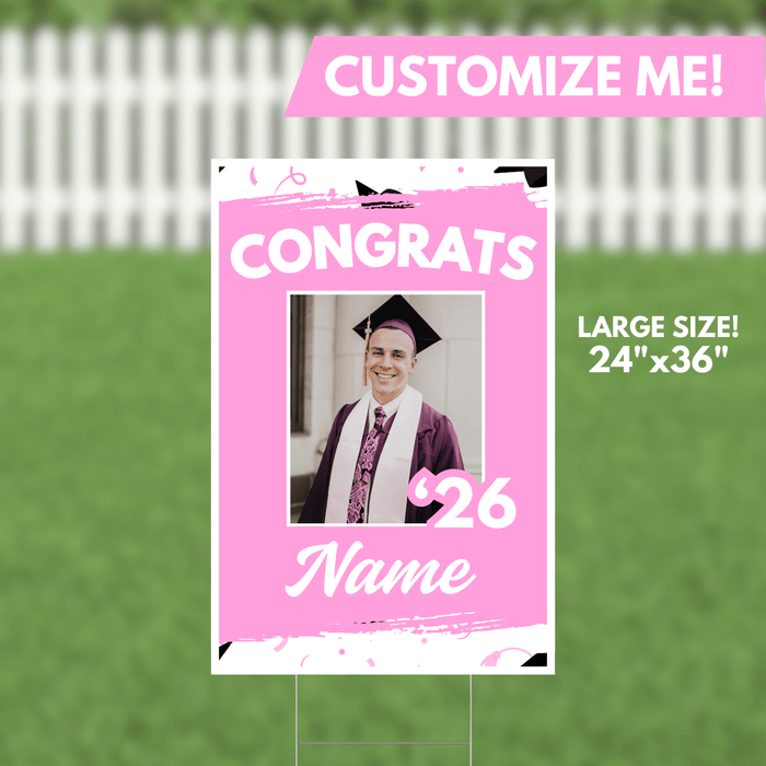 Pink yard sign with "CONGRATS" in white text, a customizable photo window, graduation year "26," and name area, measuring 24 inches by 36 inches.