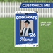 Blue graduation yard sign featuring a customizable photo frame, "CONGRATS" text, class year "26," and space for a name, measuring 24 inches by 36 inches.