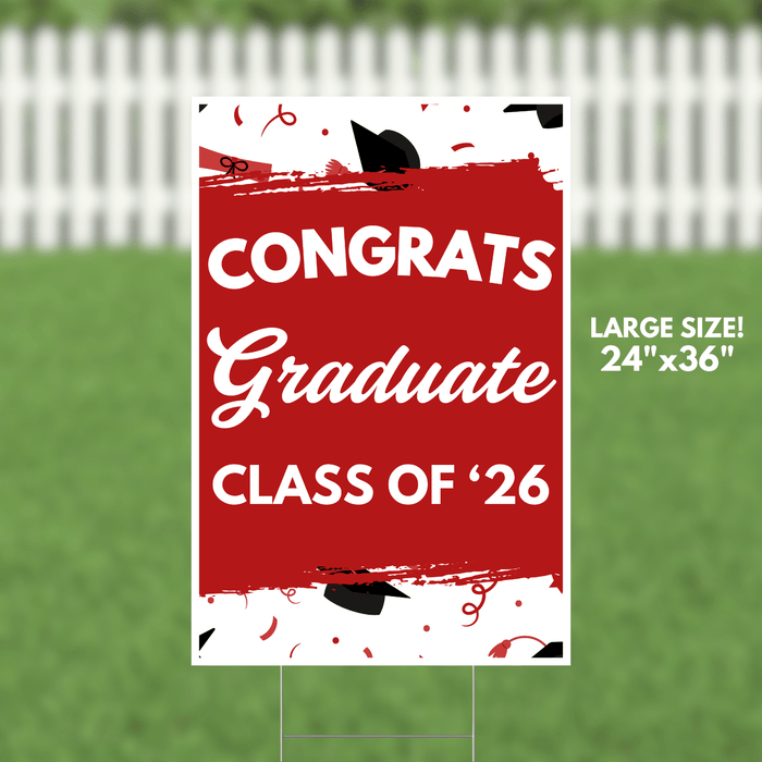 Red yard sign with white text reading "CONGRATS Graduate CLASS OF '26" featuring black graduation caps and red confetti decorations, measuring 24 inches by 36 inches.