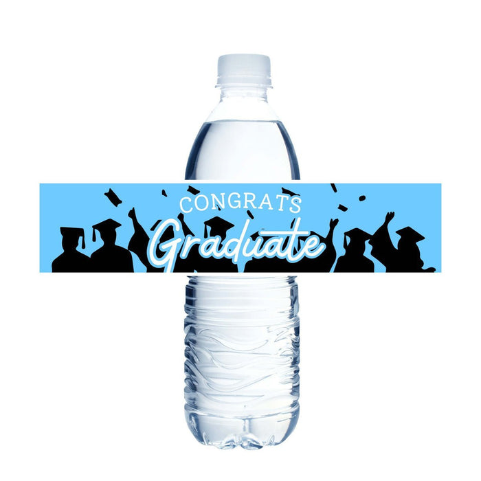Water bottle label with blue background featuring silhouettes of graduates in caps and gowns throwing mortarboards, white text reading "CONGRATS Graduate" and confetti graphics.