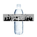 A plastic water bottle wrapped with a gray "Congrats Graduate" label featuring silhouettes of graduates in caps and gowns with confetti.