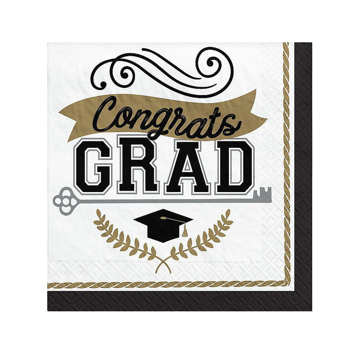 White and black beverage napkins with gold accents featuring "Congrats GRAD" text, a mortarboard cap, decorative scrollwork, and laurel wreaths.