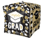 Black and gold cubical mylar balloon decorated with white and gold circles and dots, featuring a white graduation cap and "Congrats GRAD" text in gold lettering.