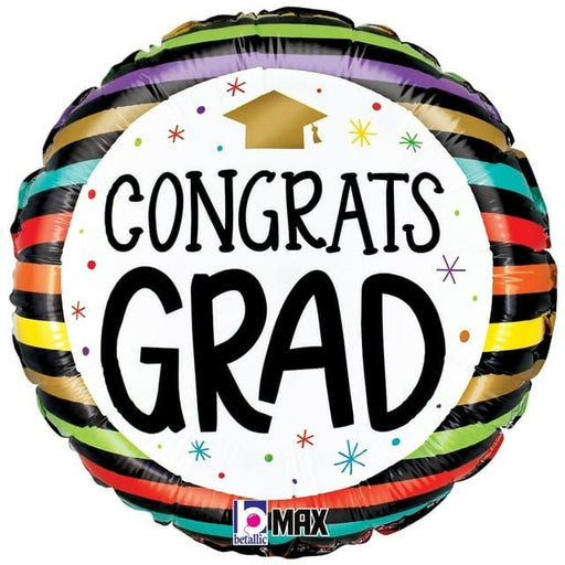 Colorful round mylar balloon with "CONGRATS GRAD" text, gold mortarboard cap, and rainbow striped border in black, green, purple, yellow, red, and teal.