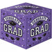Purple cubic cardboard box decorated with "Congrats Grad" text, graduation caps, stars, and confetti in black and white.