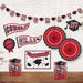 Red and black graduation decoration set featuring a banner, paper fans, cutout shapes, and themed cardstock pieces arranged on a white brick wall.