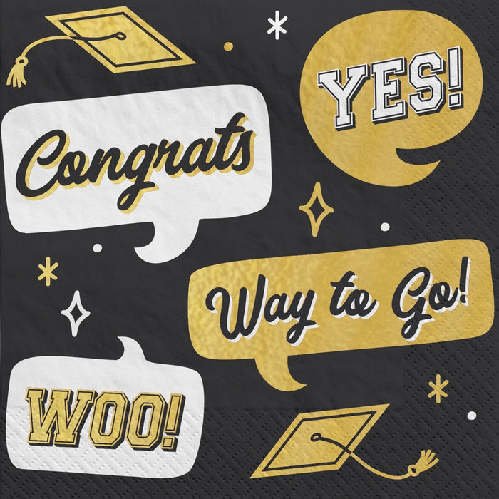 Black napkin with gold and white speech bubbles containing "Congrats," "Yes!," "Way to Go!," and "Woo!" text, plus graduation cap icons and decorative stars.
