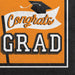Orange and black graduation-themed luncheon napkins featuring a mortarboard cap and banner with "Congrats GRAD" text in white and orange lettering.