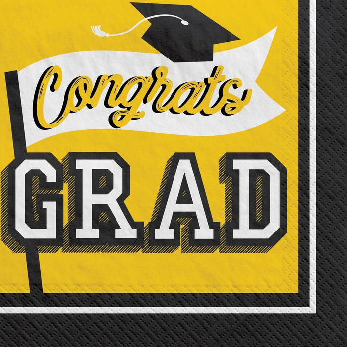 Yellow and black luncheon napkins with "Congrats Grad" text and a mortarboard cap design, pack of 40.