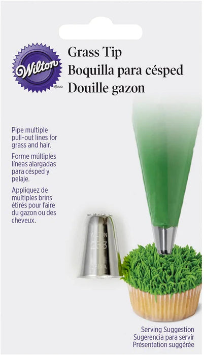Wilton Grass Tip piping nozzle shown next to a cupcake decorated with green frosting piped to resemble grass.