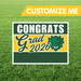 Graduation-themed sign with 'Congrats Grad 2026' on a grass background