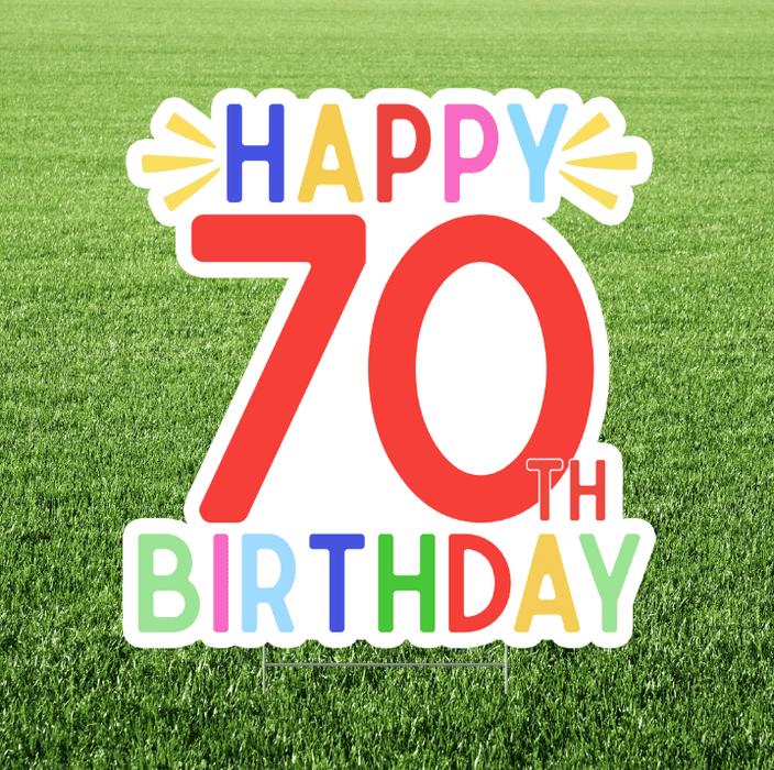 Happy 70th Birthday sign with colorful text on a grass background