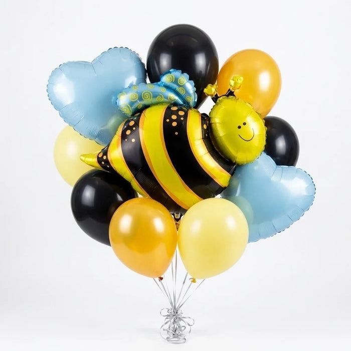 Cheerful balloon bouquet featuring a large yellow and black striped bee with a smiling face, surrounded by light blue heart-shaped foil balloons, yellow and black round latex balloons, and a blue flower-shaped foil balloon.