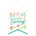 Cream canvas banner with "Happy Spring" in teal script text, surrounded by colorful illustrations of flowers, a pink bow, rabbit, strawberry, carrot, chick, and fish, finished with a scalloped teal trim at the bottom.