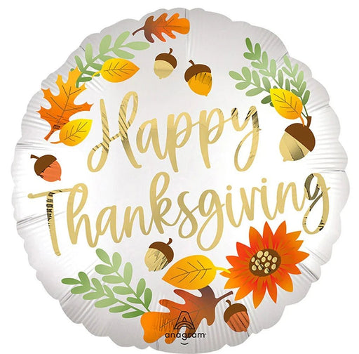 White round mylar balloon decorated with gold script reading "Happy Thanksgiving" surrounded by autumn leaves, acorns, and an orange flower.