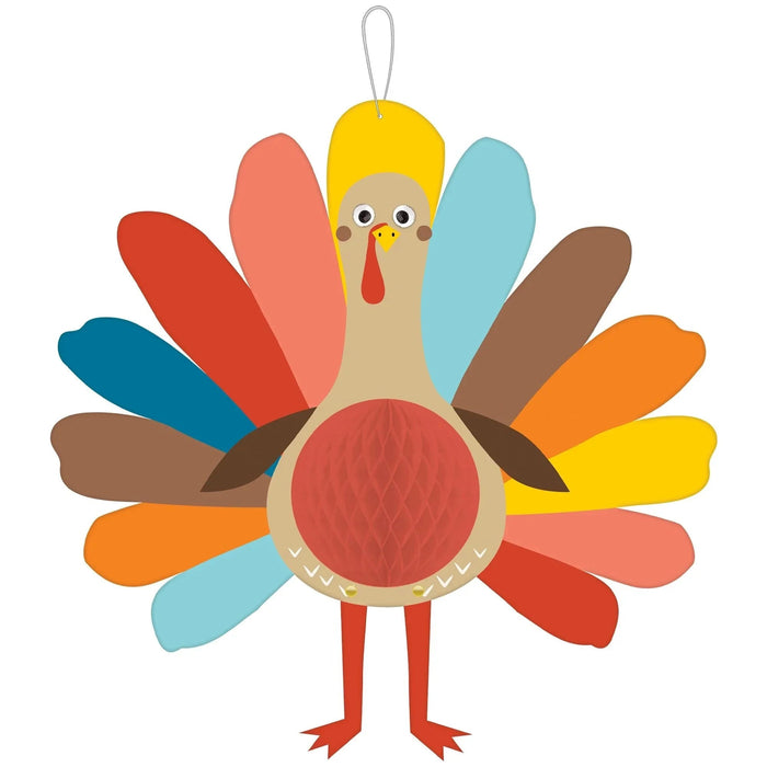Colorful paper honeycomb turkey decoration with a tan head, yellow crest, red snood, large red chest, and fan-shaped tail feathers in red, coral, yellow, orange, blue, cyan, and brown, with a metal hanging loop.