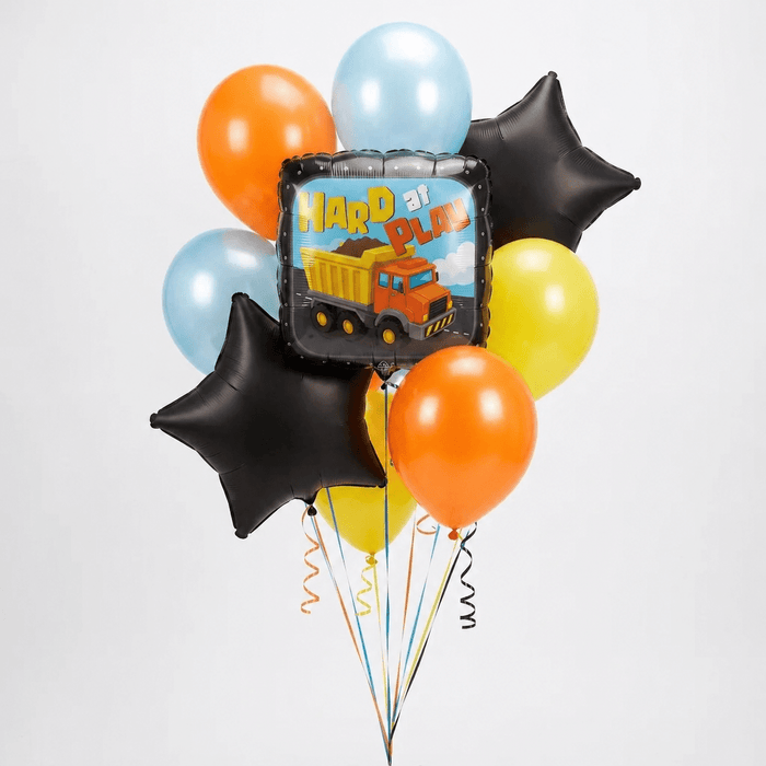 Bouquet of colorful balloons including orange, light blue, yellow, and black star-shaped foils surrounding a central square dump truck foil balloon with "Hard At Play" text.