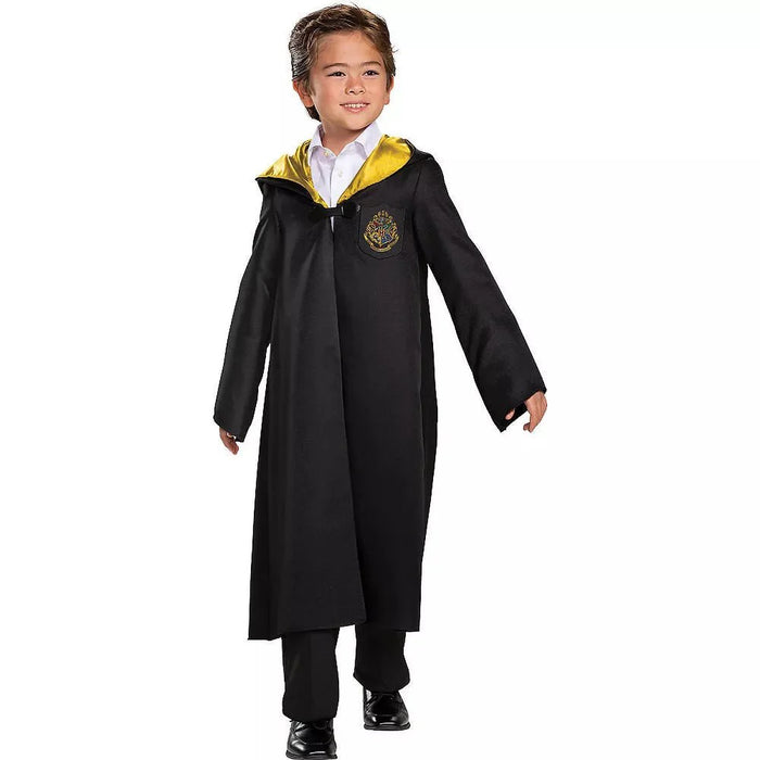 Child wearing a black wizard robe with yellow-lined hood and gold crest emblem over a white collared shirt and black pants.