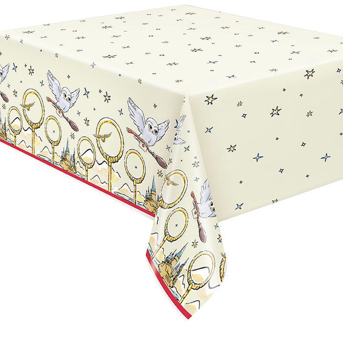 Cream-colored paper tablecover featuring golden rings, castle illustrations, and blue owls with scattered stars throughout, red trim along the bottom edge.