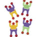 Four colorful sticky wall tumblers with purple bodies, yellow or green tops, and red adhesive balls attached to outstretched arms and legs.