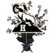 Black and gold ram logo with letter H on a black base, surrounded by decorative star sprays, mounted on a black ribbon-tied pedestal centerpiece.