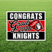 Red, black, and white yard sign reading "Congrats Grad 2026 Knights" with a knight logo, displayed on green grass.