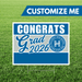 Graduation-themed customizable sign with 'Congrats Grad 2026' text on a grass background