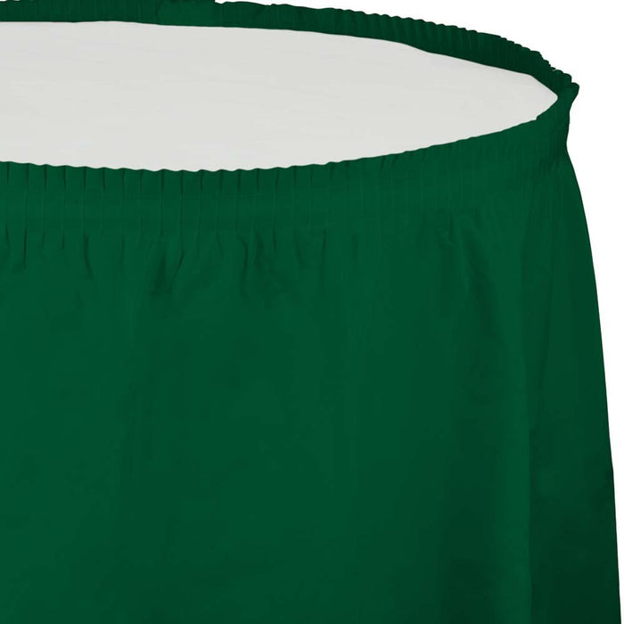 Hunter green pleated table skirt with elastic waistband shown laid flat against a light background.