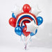 Patriotic balloon bouquet with red, white, and blue metallic balloons, white star-shaped balloons, and a large rainbow-striped centerpiece balloon arranged on ribbons.