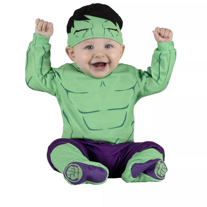 Baby wearing a green muscular chest costume with purple pants, black hair headband, and green boots with purple accents.