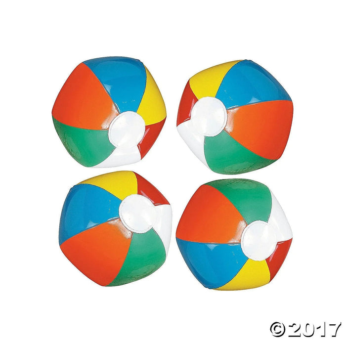 Four colorful inflatable beach balls with alternating panels in red, blue, yellow, and green, each featuring a white center circle.