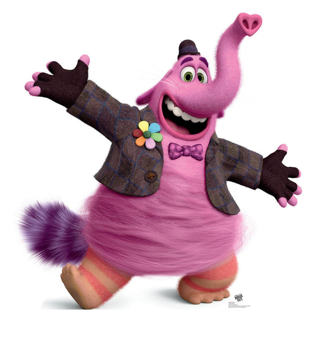 Pink furry character with a long curved tail topped with a heart shape, wearing a brown tweed jacket with a colorful flower pin and purple bow tie, with an enthusiastic expression and outstretched arms.