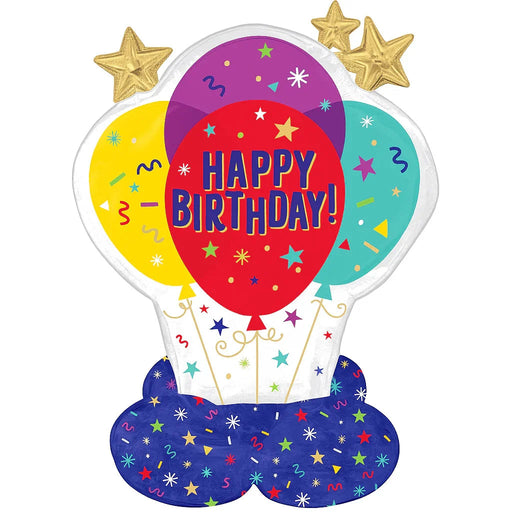 Colorful hot air balloon-shaped foil balloon with red center reading "HAPPY BIRTHDAY" in blue letters, surrounded by yellow and turquoise balloons, gold stars on top, and dark blue base decorated with stars and confetti.