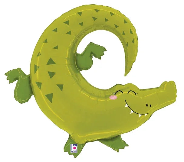 Green foil balloon shaped like a smiling alligator with triangular scale patterns, curved tail, and outstretched limbs in a playful pose.