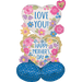 Heart-shaped mylar balloon decorated with colorful pink, purple, and blue flowers and the text "Love You" above a gold-trimmed section reading "Happy Mother's Day" with a blue polka-dotted base section.