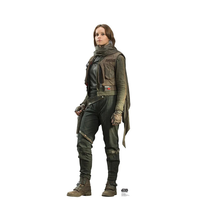 Woman wearing olive-green military-style outfit with layered tunic, matching pants, wrapped scarf, and brown boots against white background.