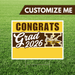 Graduation-themed customizable sign with 'Congrats Grad 2026' text on a grass background