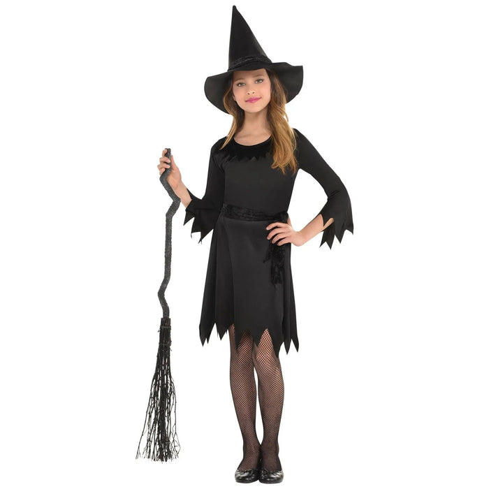 Child wearing a black witch costume with a pointed hat, ragged-hem dress, jagged-cuff long sleeves, black fishnet tights, and holding a black broomstick.