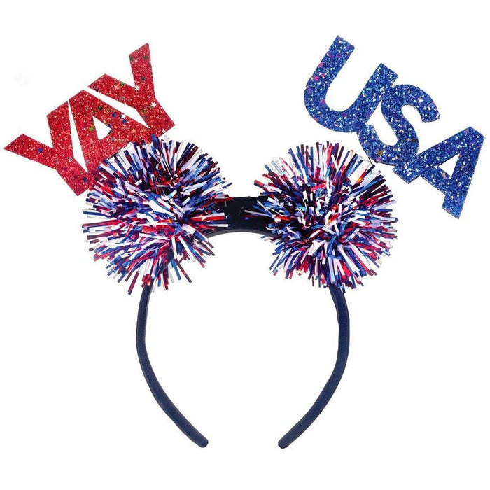 Red glitter "YAY" and blue glitter "USA" letters attached to a black headband with two large red, white, and blue pom-poms on springs.